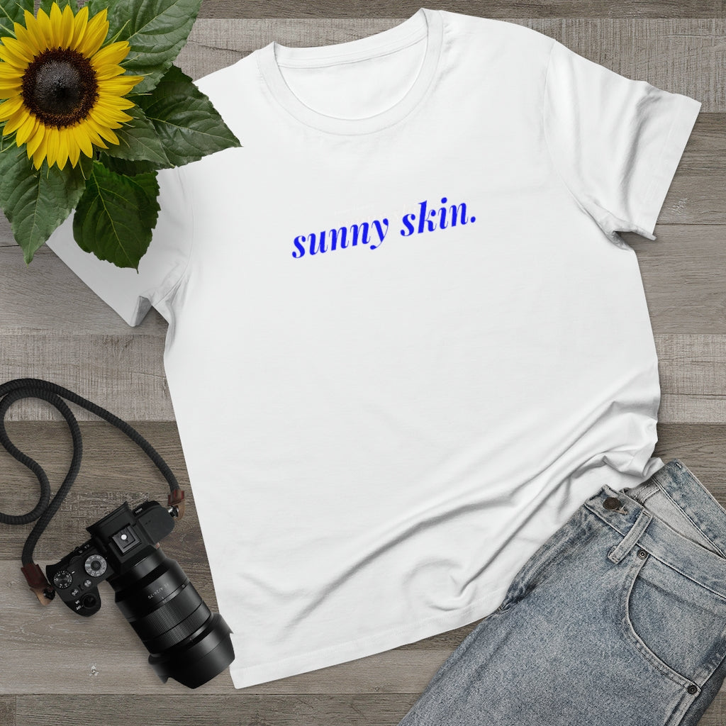 A creative shot featuring white t-shirt with a sunny skin design on it on Spa Circle Brands product listing page.
