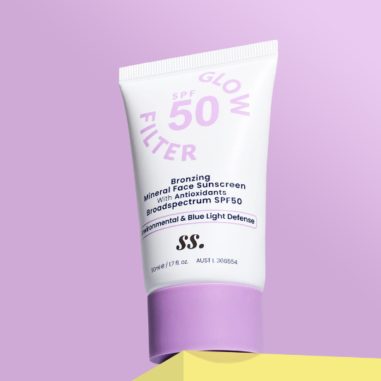 A tube of Sunny Skin Glow Filter SPF50 on a violet background uploaded on Spa Circle Brands product listing page. 