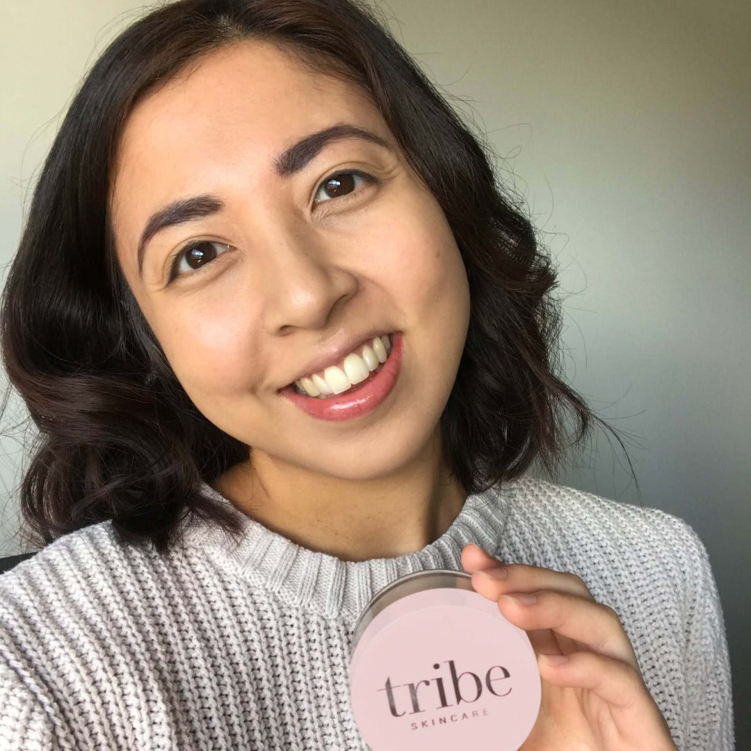 A young confident woman showcasing her face with the full coverage of Tribe Mineral Makeup Powder MEDIUM/TAN, featured on Spa Circle Brands' product listing.