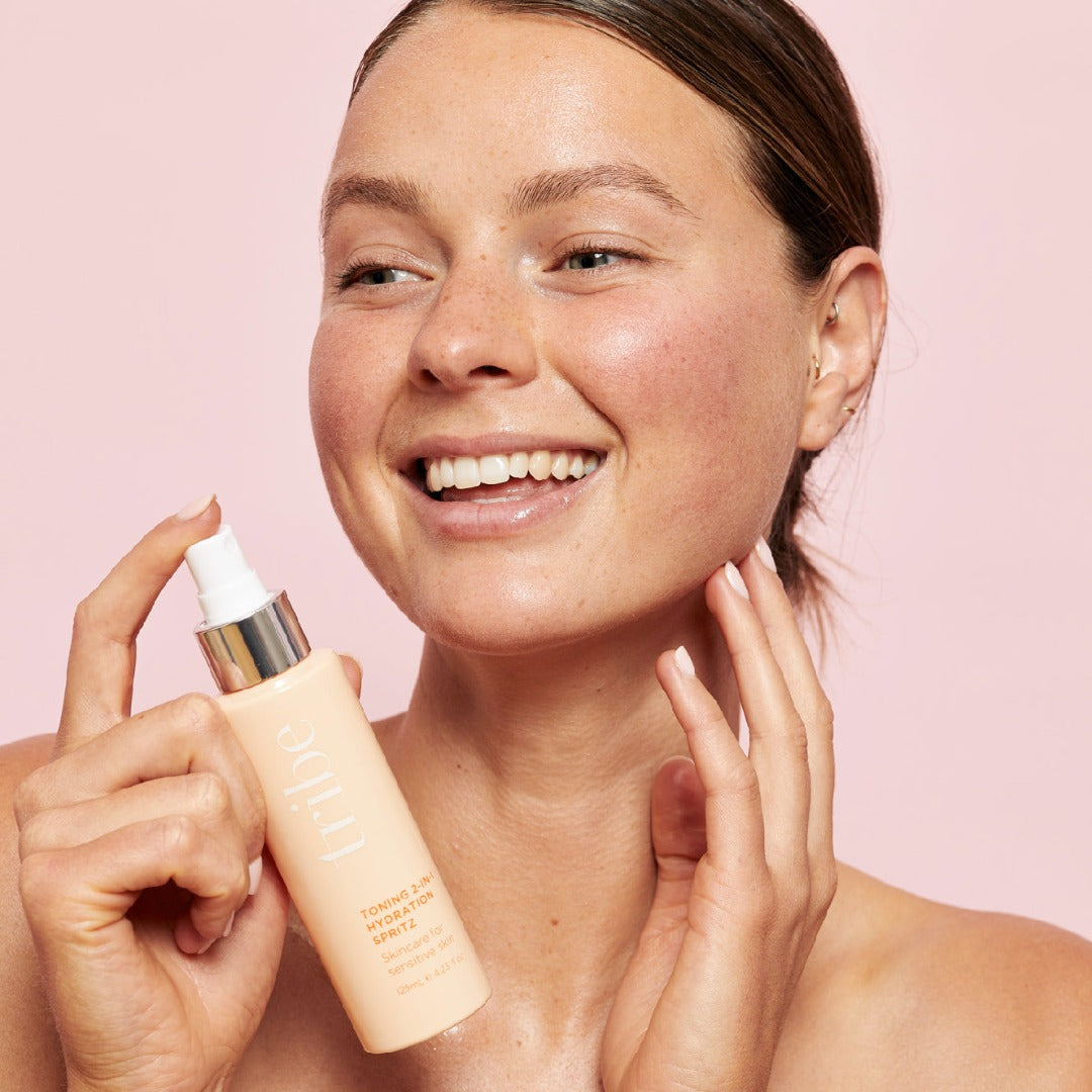 Photo of a woman holding Tribe Toning 2-in-1 Hydration Spritz  125 ml bottle skincare for sensitive skin, showcased on Spa Circle Brands' product listing.