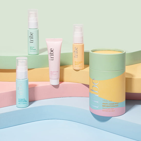 Eye-catching arrangement of the Tribe Trial/Travel Kit, featuring both the ANTI-AGEING and BRIGHTENING variants, set against a backdrop of soothing pastel shades. This captivating presentation is part of Spa Circle Brands' product listing, offering a glimpse into the rejuvenating and illuminating options provided by the kit.